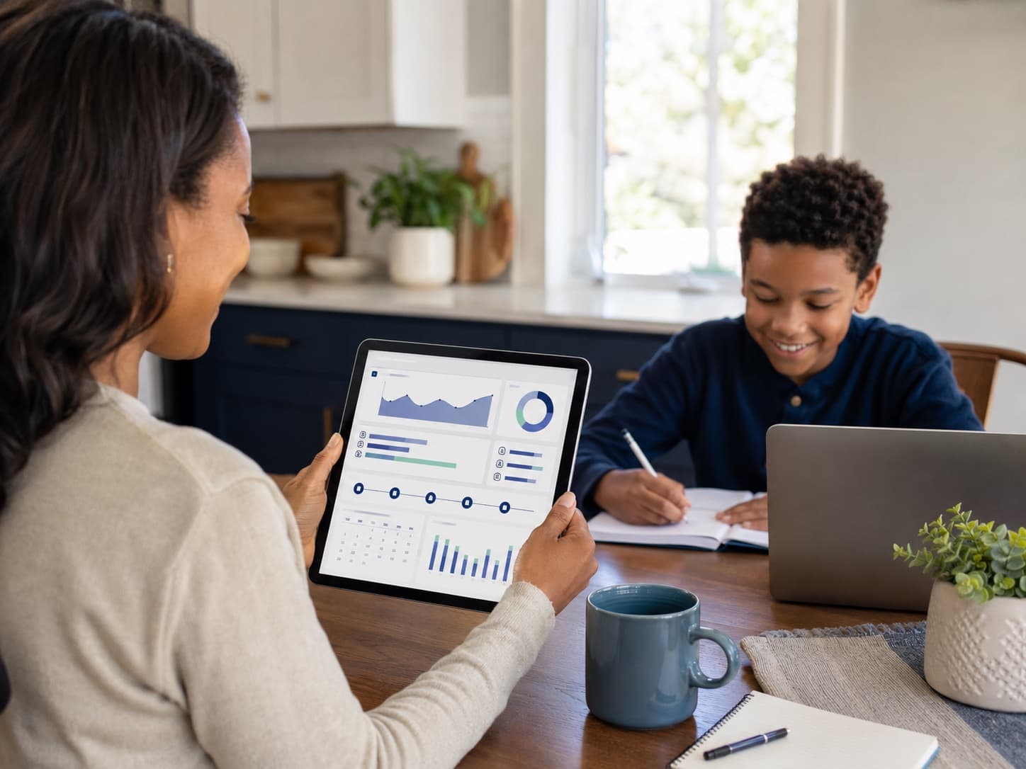 A parent reviewing their student's progress dashboard on a tablet while the student does homework nearby